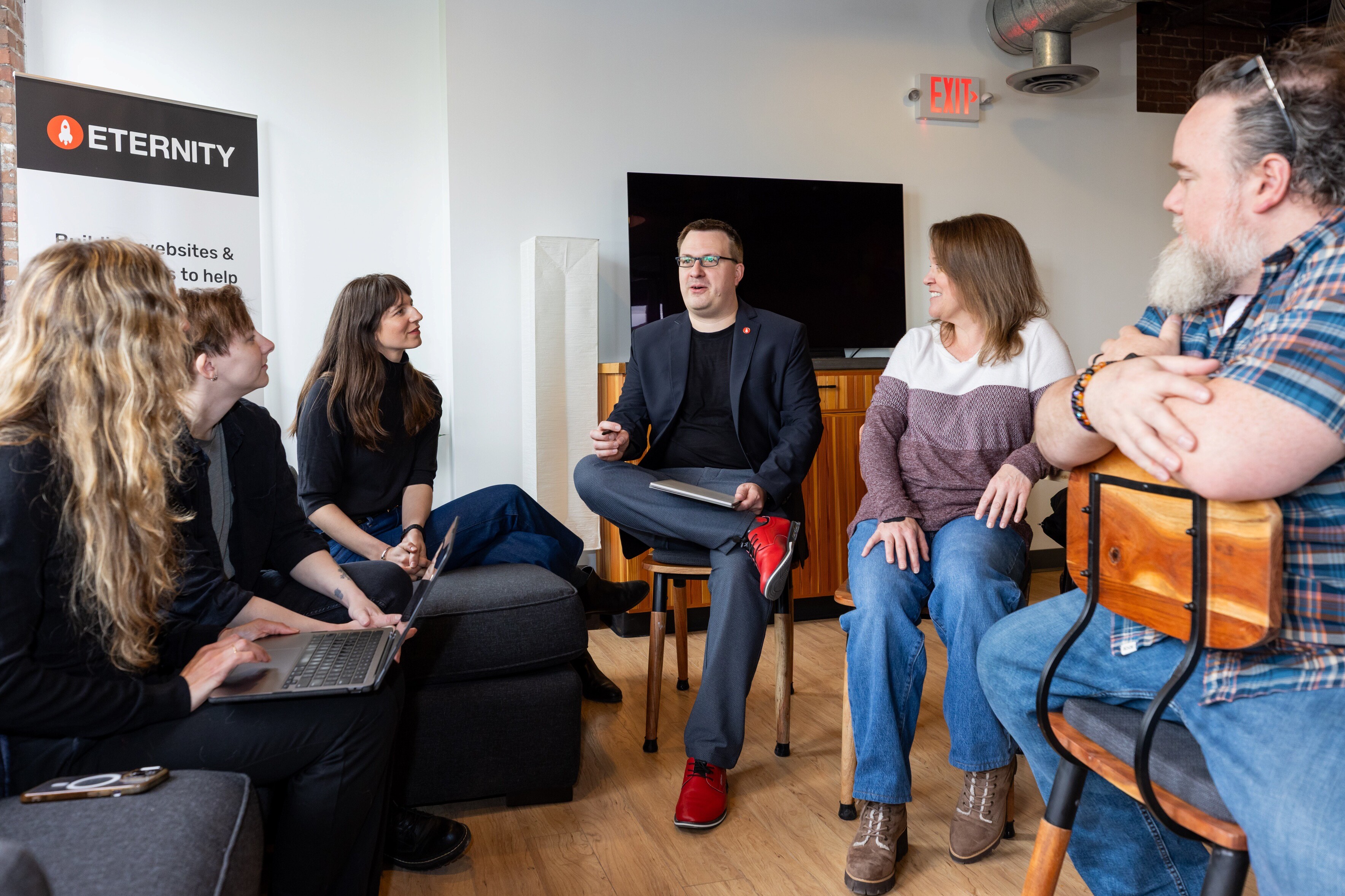 A group meeting discussing website design strategies in a modern workspace.