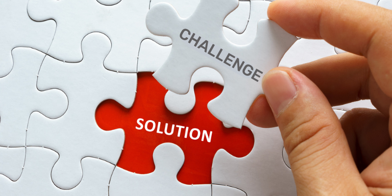 Piece of jigsaw puzzle with the word CHALLENGE SOLUTION.