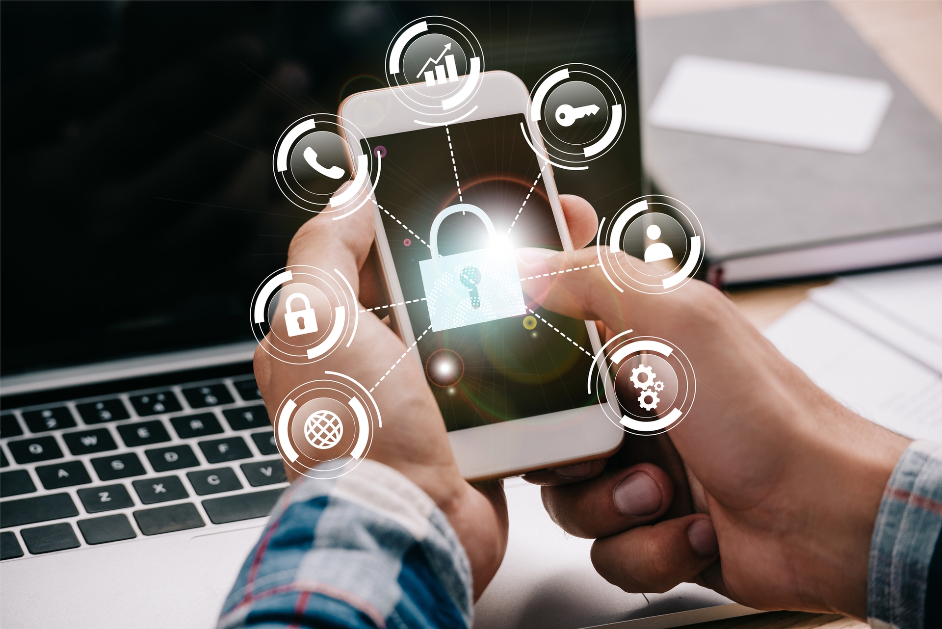 Cropped shot of businessman using smartphone with cyber security signs